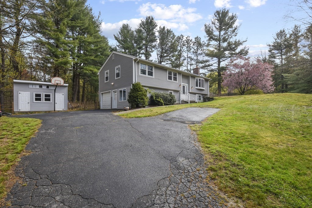 39 Tanglewood Road Sterling, MA 01564 - Photo 30 of 30 a front view of a house with a yard and garage