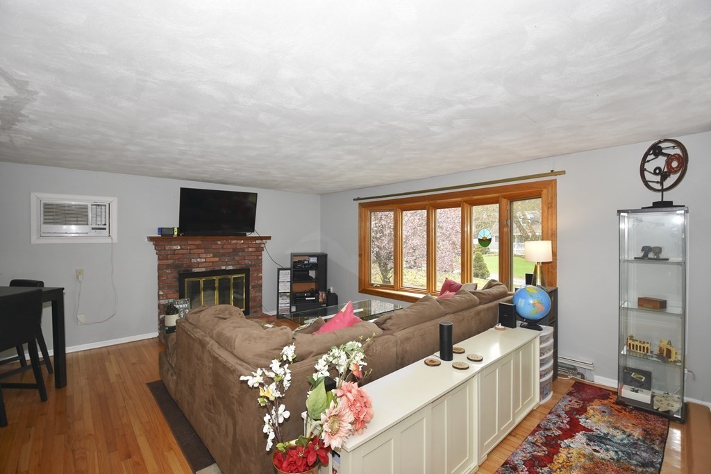 39 Tanglewood Road Sterling, MA 01564 - Photo 5 of 30 a living room with furniture a flat screen tv and a fireplace