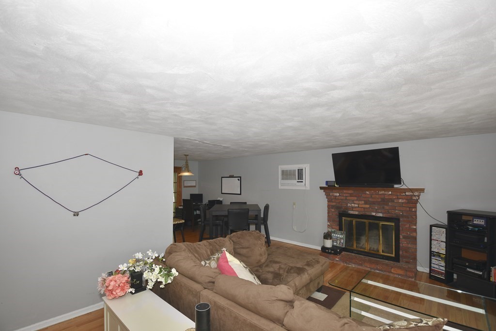 39 Tanglewood Road Sterling, MA 01564 - Photo 6 of 30 a living room with furniture a flat screen tv and a fireplace