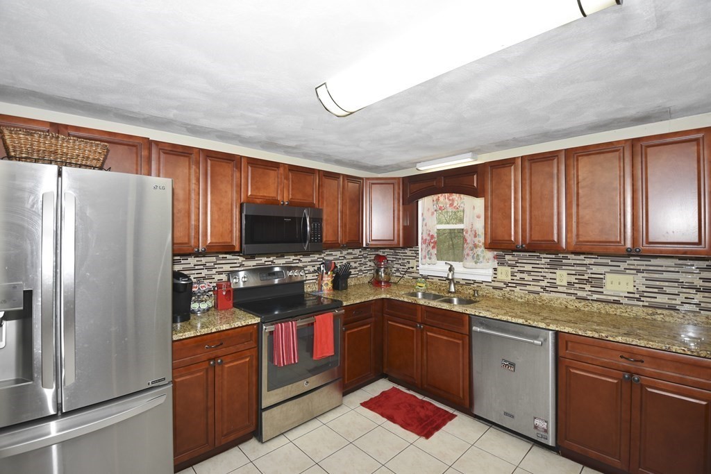 39 Tanglewood Road Sterling, MA 01564 - Photo 10 of 30 a kitchen with stainless steel appliances sink stove refrigerator and cabinets