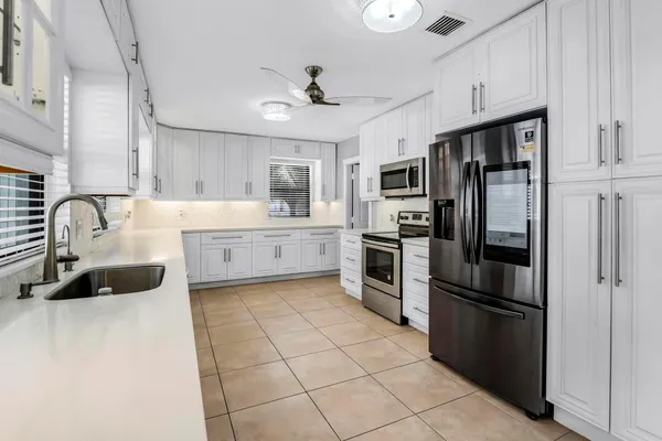 a view of a room with chairs and table