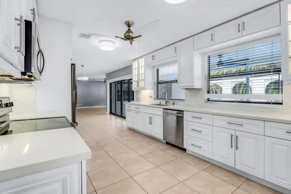 front view of house with a yard and potted plants