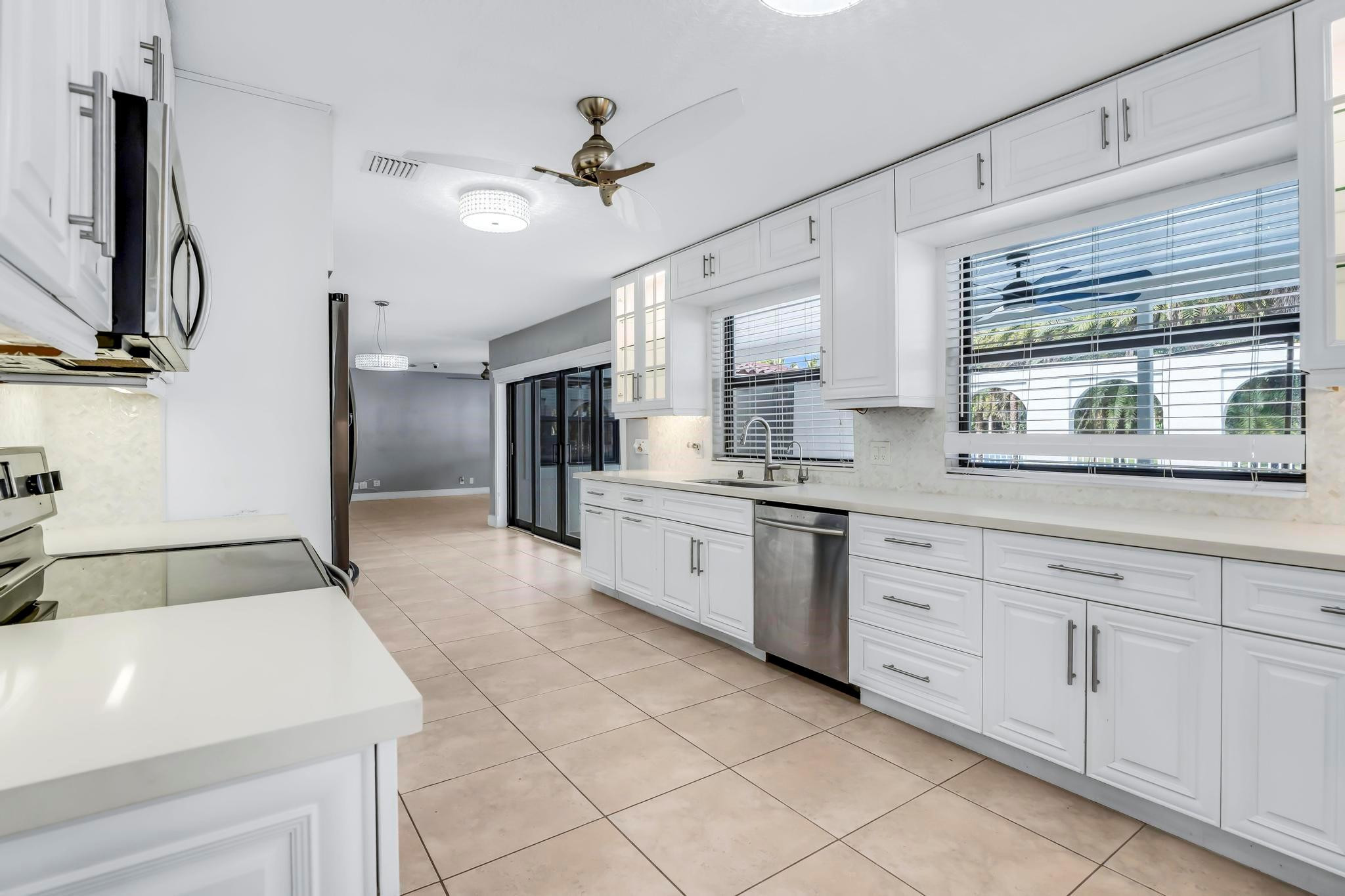 18201 Southwest 70th Place Southwest Ranches, FL 33331 - Photo 20 of 55 a kitchen with granite countertop a sink stainless steel appliances and cabinets