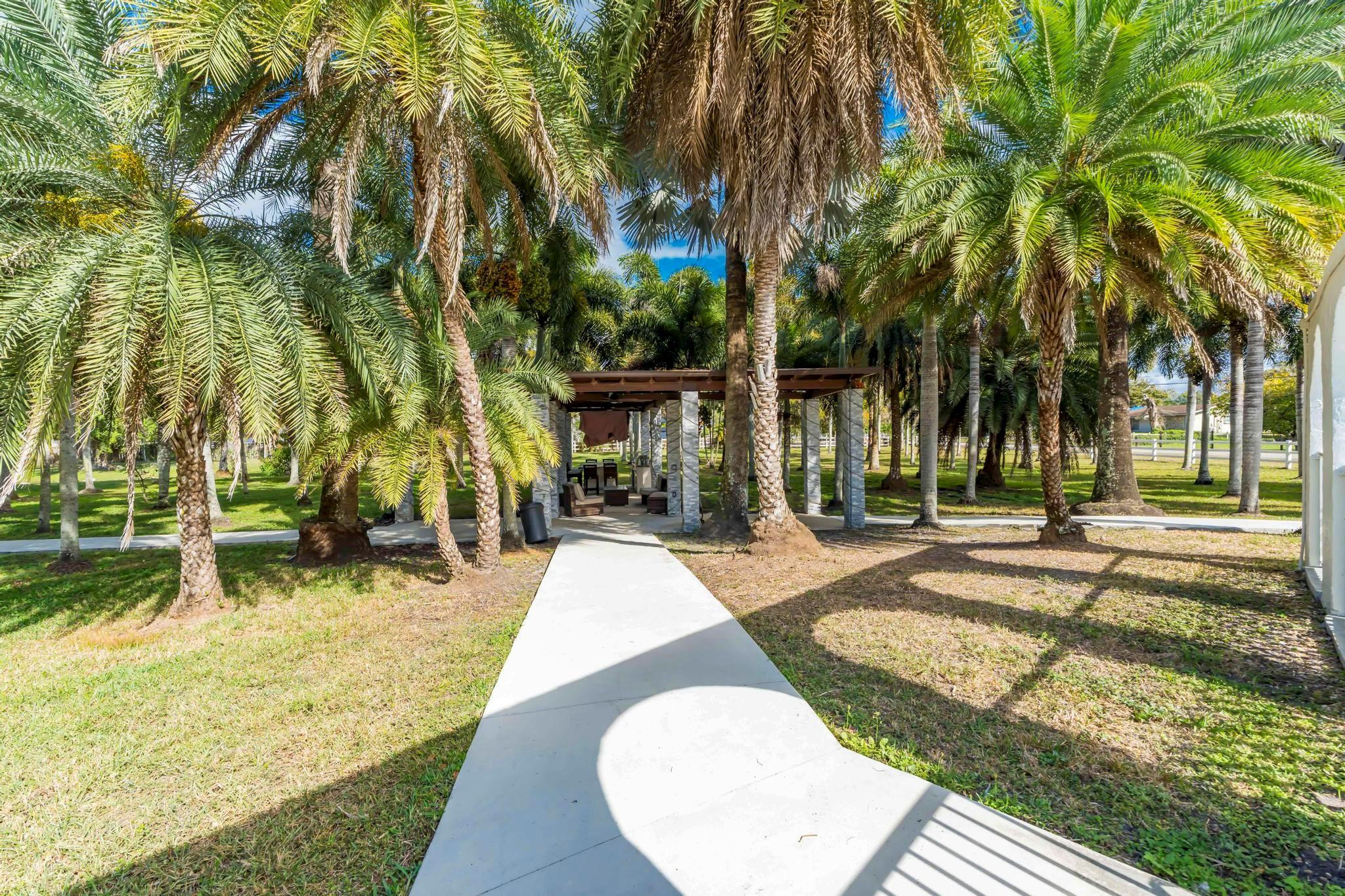 18201 Southwest 70th Place Southwest Ranches, FL 33331 - Photo 40 of 55 front view of a house with a yard