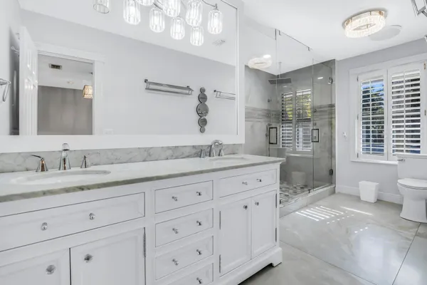 a kitchen with granite countertop a sink stainless steel appliances and cabinets