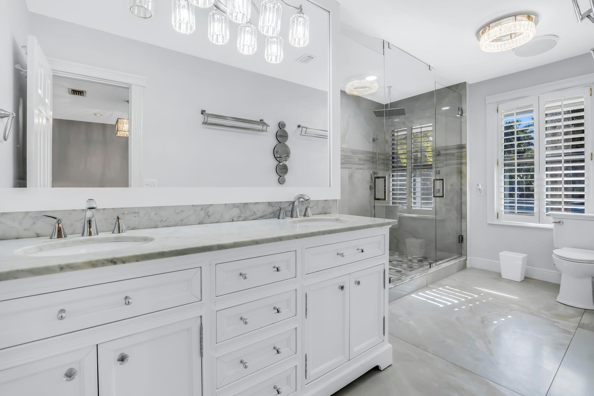 18201 Southwest 70th Place Southwest Ranches, FL 33331 - Photo 8 of 55 a spacious bathroom with double sink a toilet a mirror and shower