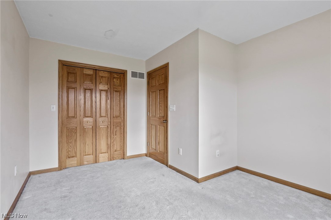 411 Adario West Road Shiloh, OH 44878 - Photo 24 of 35 Unfurnished bedroom with light carpet and a closet