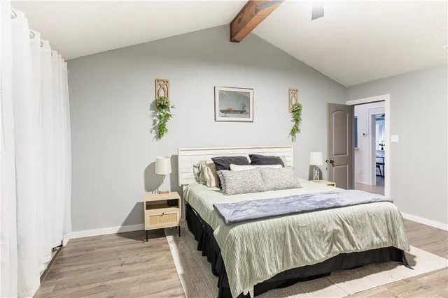 a bedroom with a bed and a painting on the wall