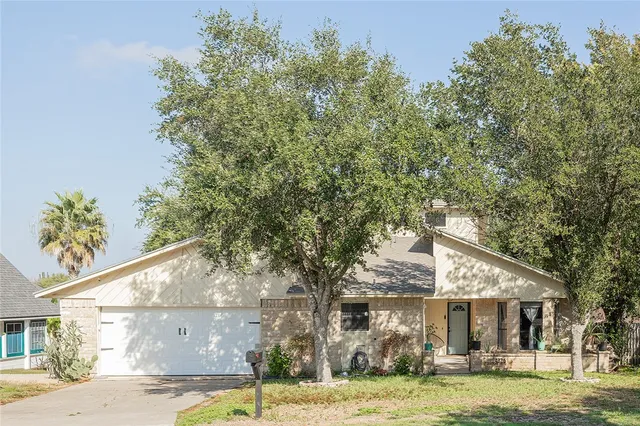 a backyard of a house with yard table and chairs