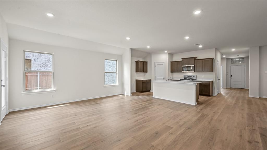 6088 Freedom Drive Lindale, TX 75706 - Photo 15 of 40 a view of kitchen with kitchen island a sink dishwasher stove with wooden floors