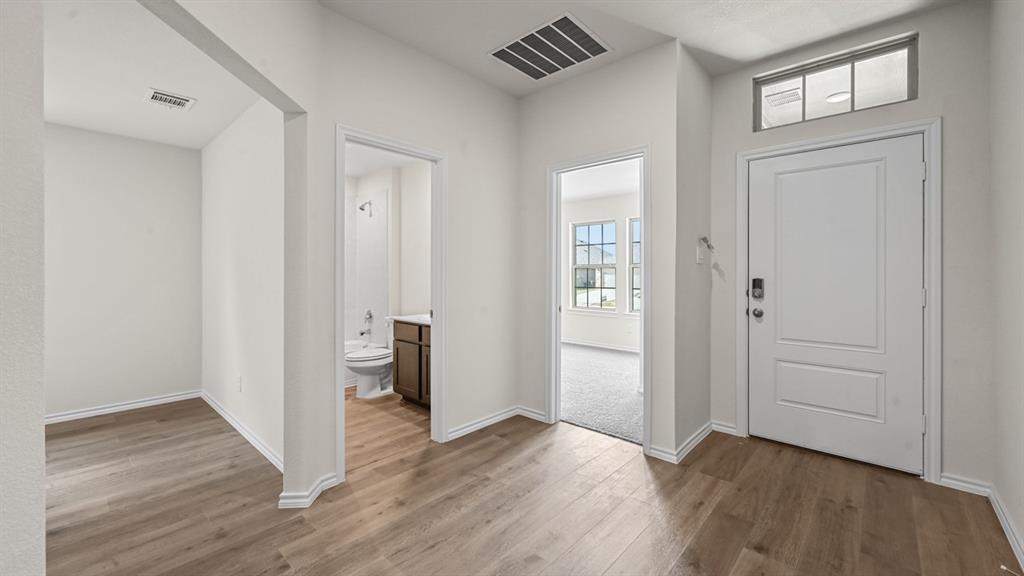 6088 Freedom Drive Lindale, TX 75706 - Photo 16 of 40 a view of an empty room with wooden floor and closet