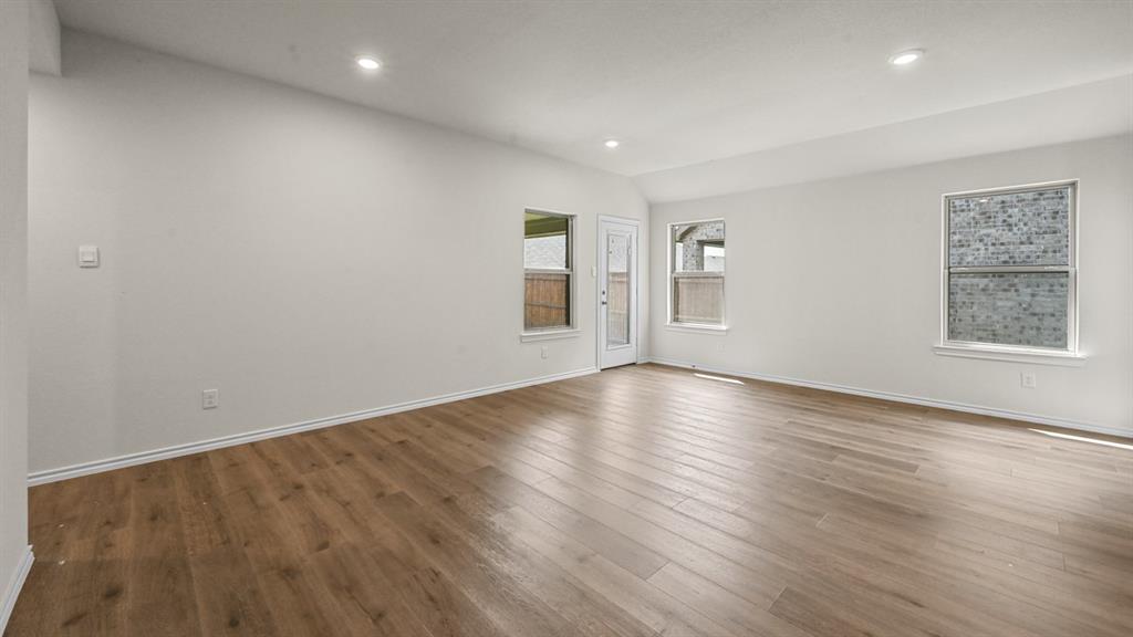 6088 Freedom Drive Lindale, TX 75706 - Photo 17 of 40 an empty room with wooden floor and windows