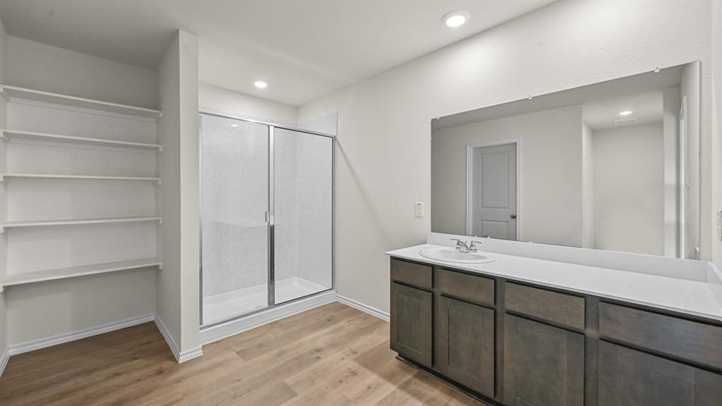 6088 Freedom Drive Lindale, TX 75706 - Photo 27 of 40 a bathroom with a double vanity sink and mirror