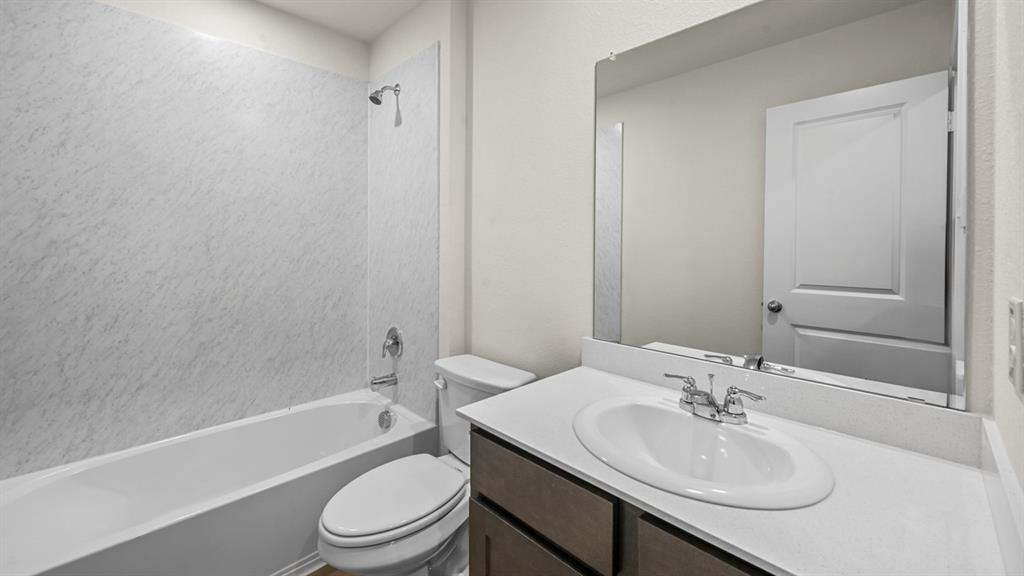 6088 Freedom Drive Lindale, TX 75706 - Photo 33 of 40 a bathroom with a sink toilet and shower