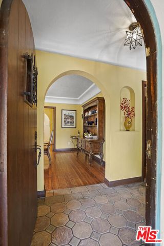a living room with furniture and floor to ceiling windows