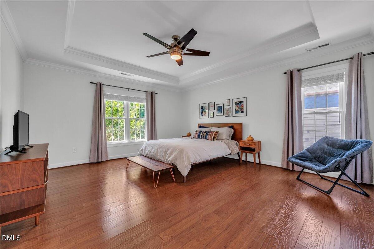 2908 Oak Bridge Drive Raleigh, NC 27610 - Photo 23 of 47 a bedroom with a bed and wooden floor