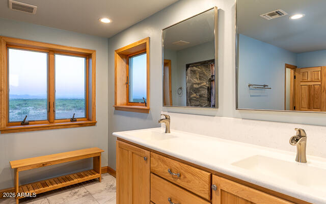 6233 West Airport Road Willcox, AZ 85643 - Photo 29 of 54 a bathroom with a sink and a large mirror