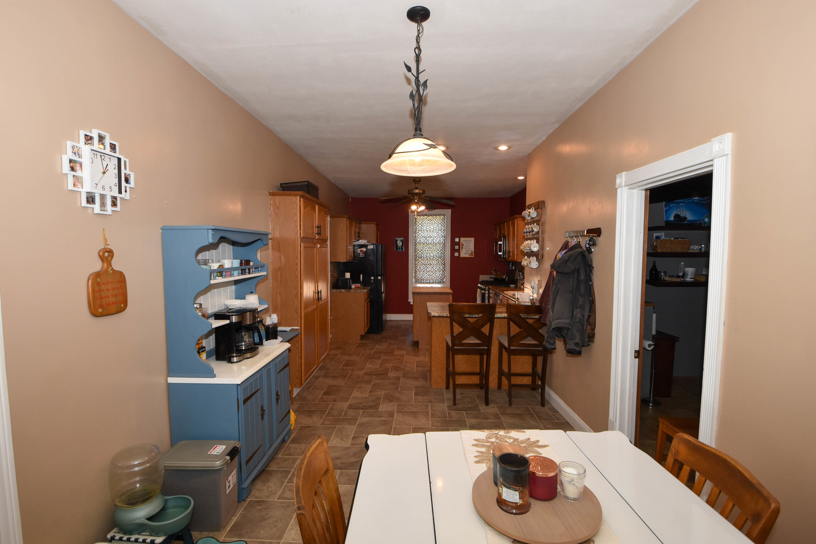 610 North Main Street Le Roy, IL 61752 - Photo 11 of 22 a hallway with a dining table a chandelier and a stove