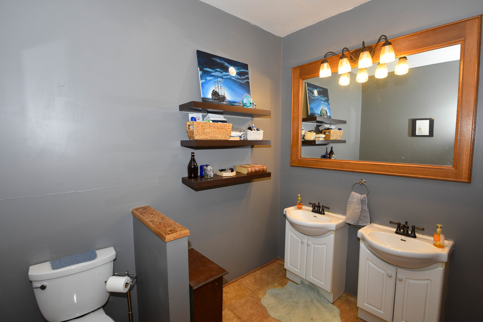 610 North Main Street Le Roy, IL 61752 - Photo 12 of 22 a white toilet sitting next to a bathroom sink and vanity