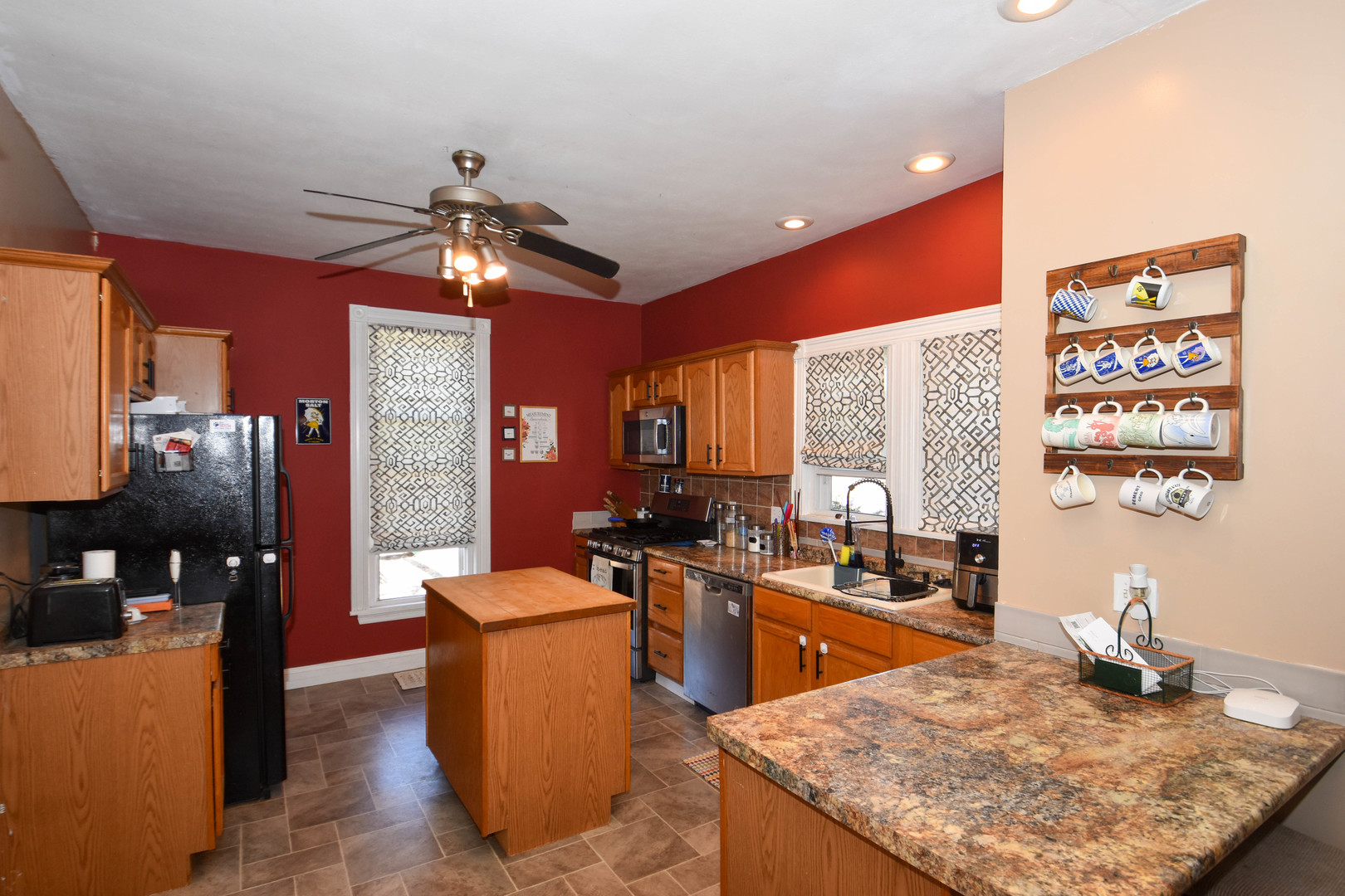 610 North Main Street Le Roy, IL 61752 - Photo 8 of 22 a kitchen with stainless steel appliances granite countertop a sink dishwasher stove and refrigerator with wooden floor