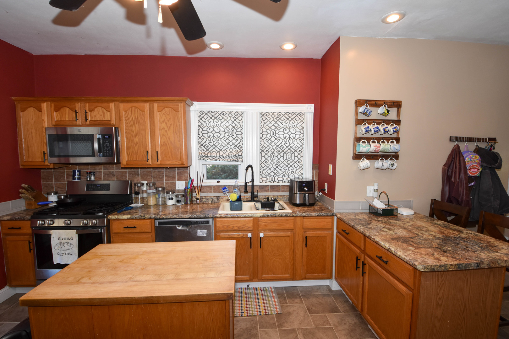 610 North Main Street Le Roy, IL 61752 - Photo 9 of 22 a kitchen with stainless steel appliances granite countertop a sink stove and microwave