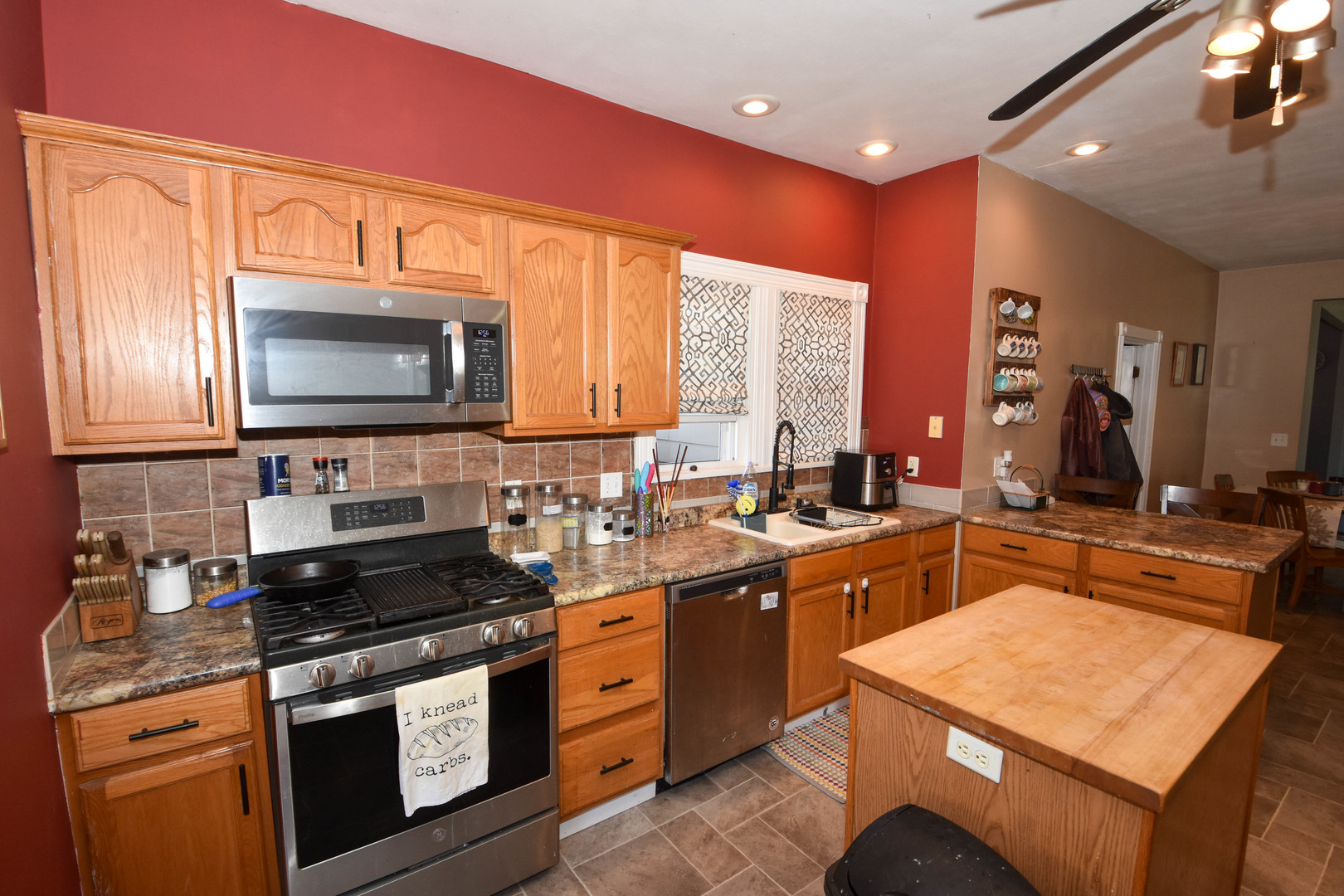 610 North Main Street Le Roy, IL 61752 - Photo 10 of 22 a kitchen with stainless steel appliances a stove sink microwave and cabinets