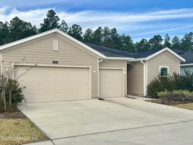 a view of garage yard and front view of a house