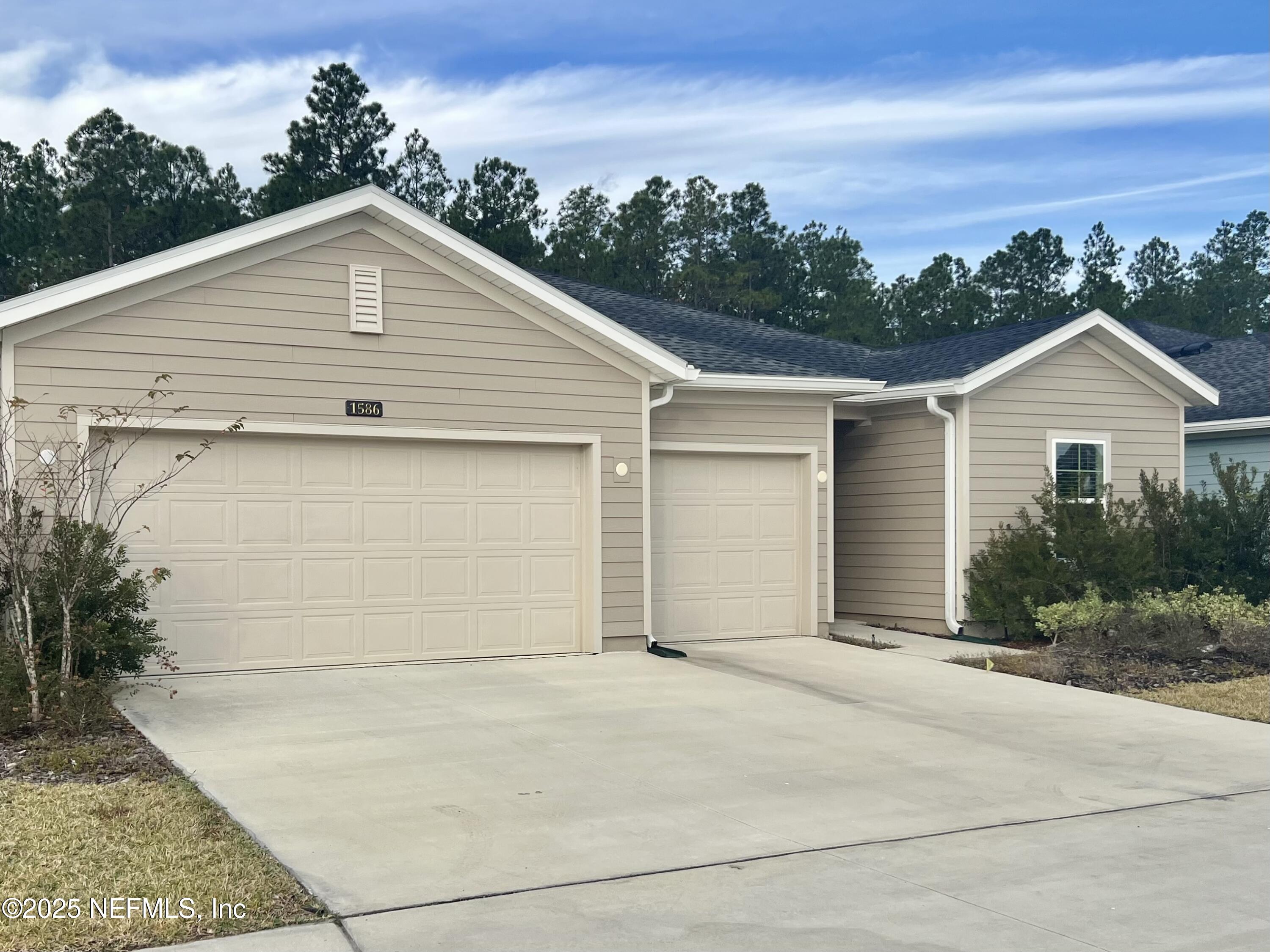 a view of garage yard and front view of a house