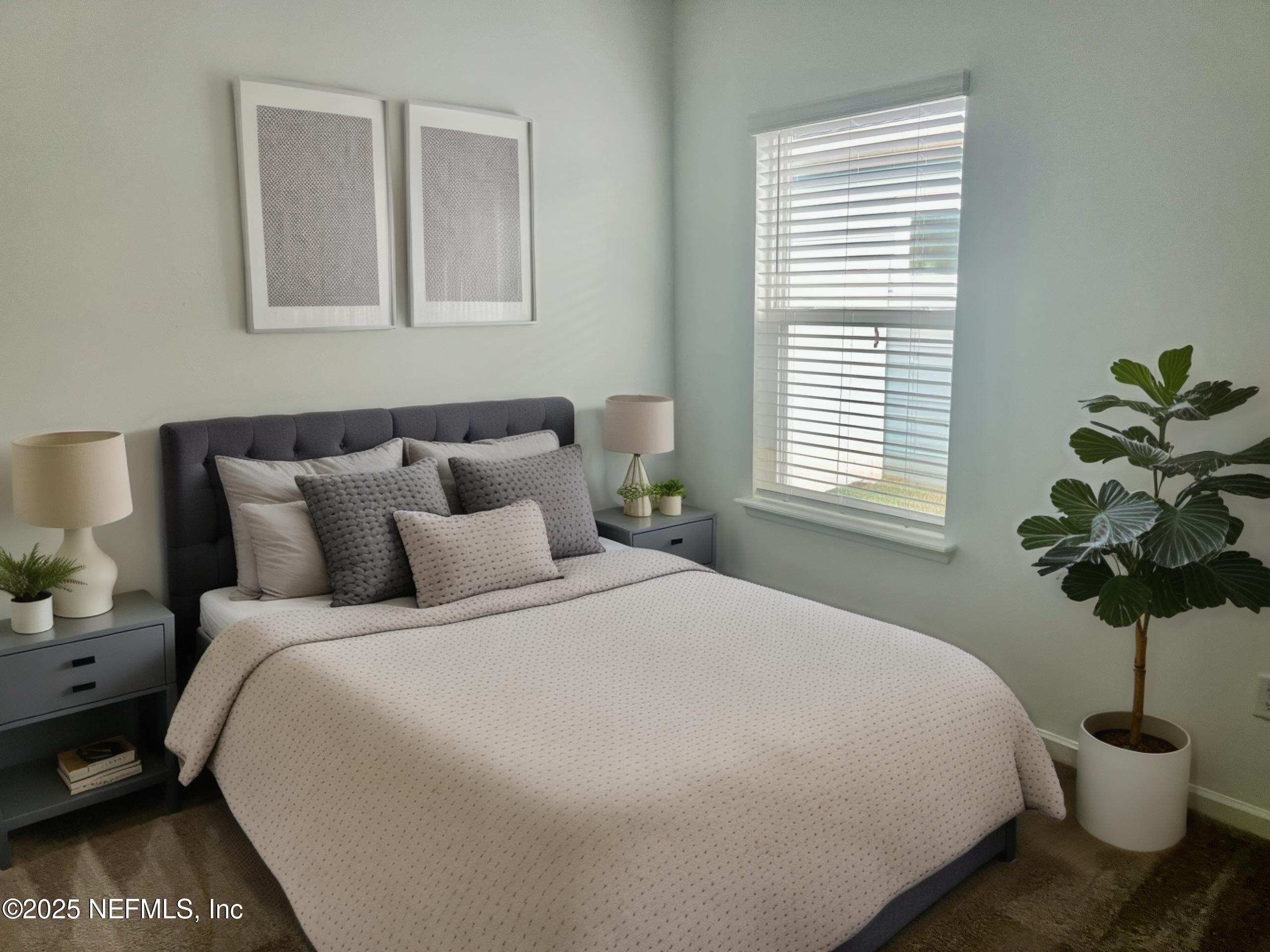 1586 Lachlan Circle Jacksonville, FL 32218 - Photo 11 of 16 a bedroom with a bed and a potted plant