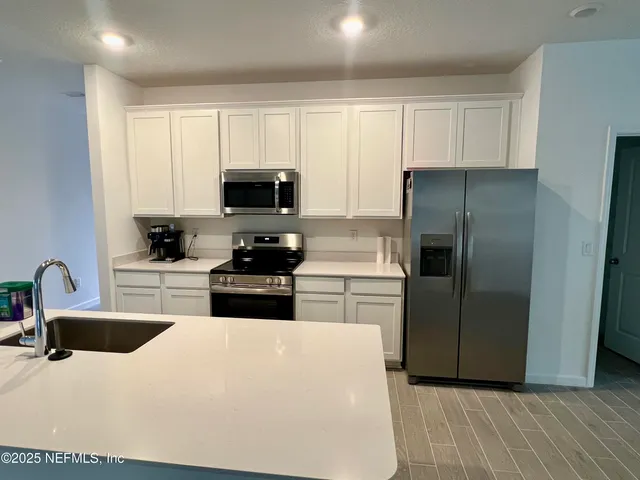 a kitchen with a refrigerator stove and sink