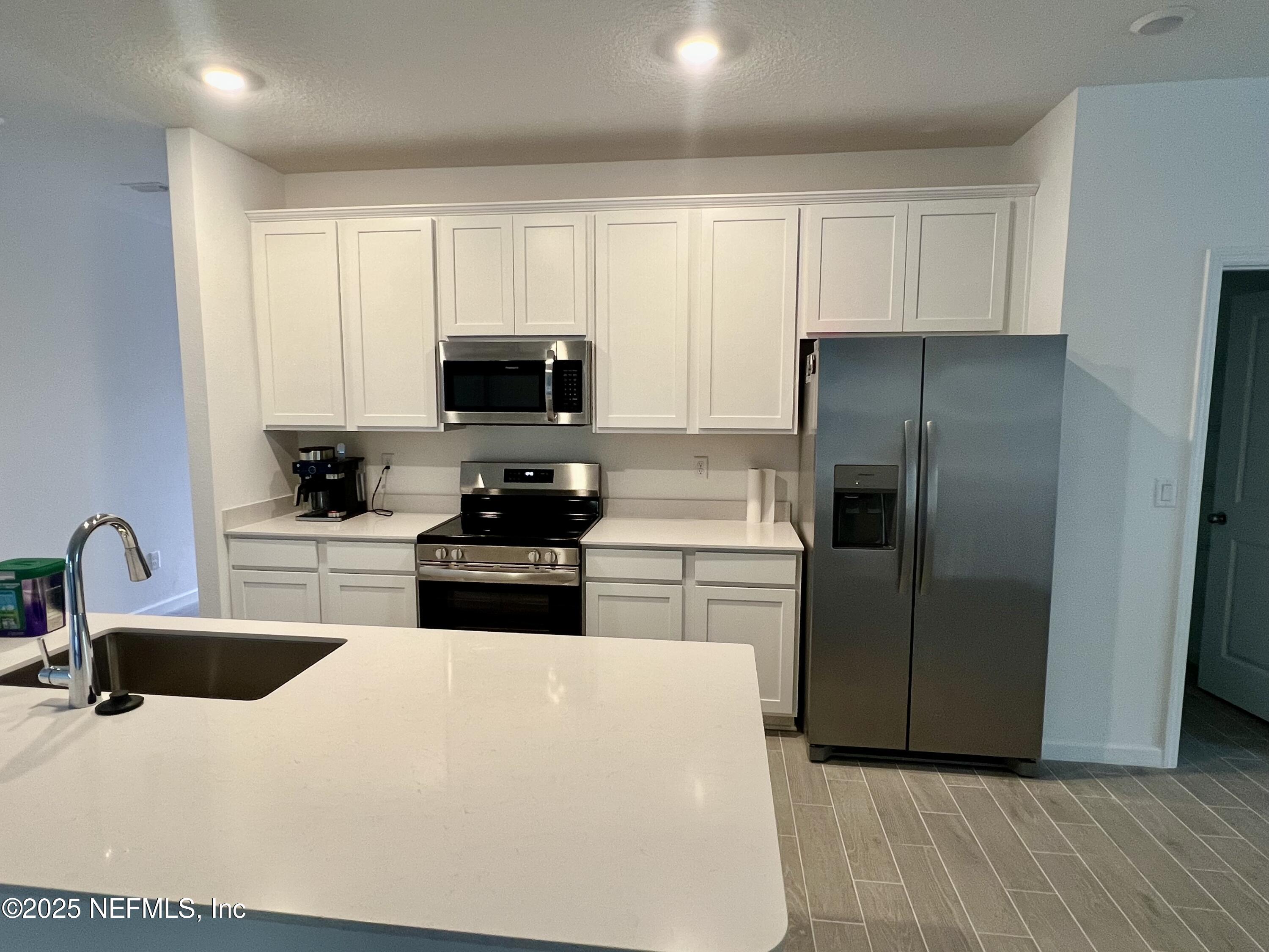 1586 Lachlan Circle Jacksonville, FL 32218 - Photo 4 of 16 a kitchen with a refrigerator stove and sink