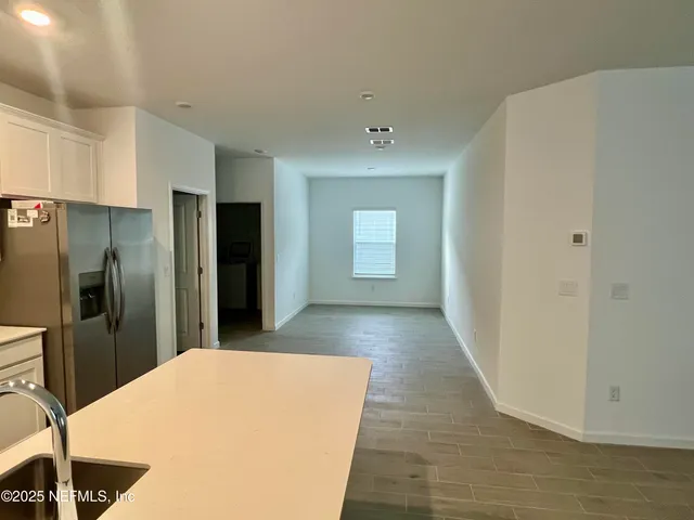 a kitchen with stainless steel appliances a refrigerator and a stove top oven