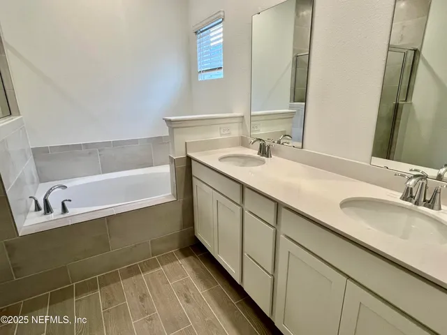 a bathroom with a sink double vanity and a bathtub