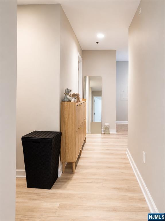 3418 City Place, Unit 3418 Edgewater, NJ 07020 - Photo 3 of 10 a view of a living room with wooden floor