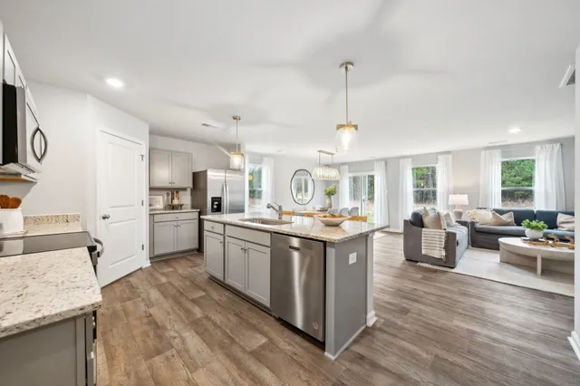 a kitchen with lots of counter top space and wooden floor