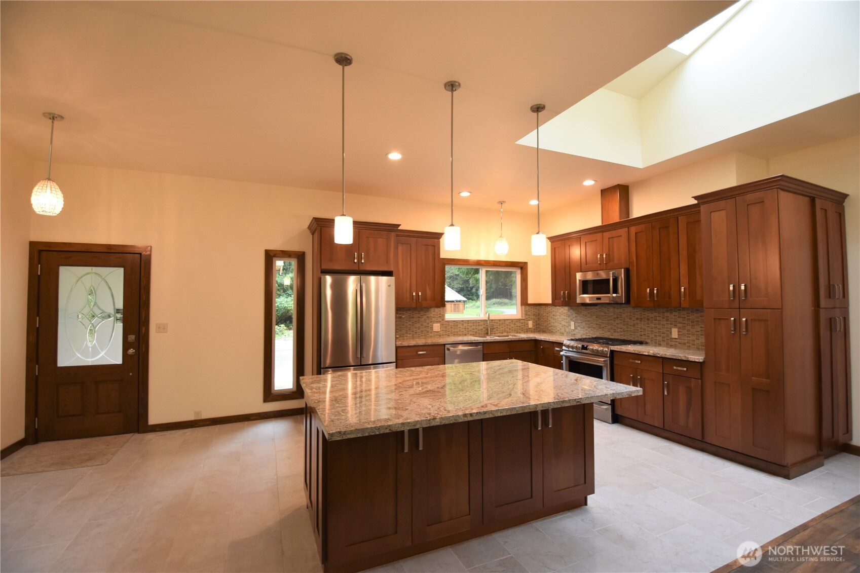 30331 Heimer Road Arlington, WA 98223 - Photo 20 of 37 a kitchen with stainless steel appliances granite countertop a refrigerator a sink and wooden cabinets