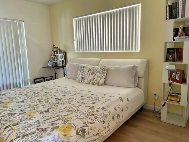 a large bed sitting in a bedroom next to a window