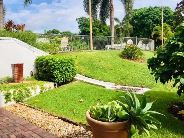 a view of a swimming pool and a fountain in front of the house