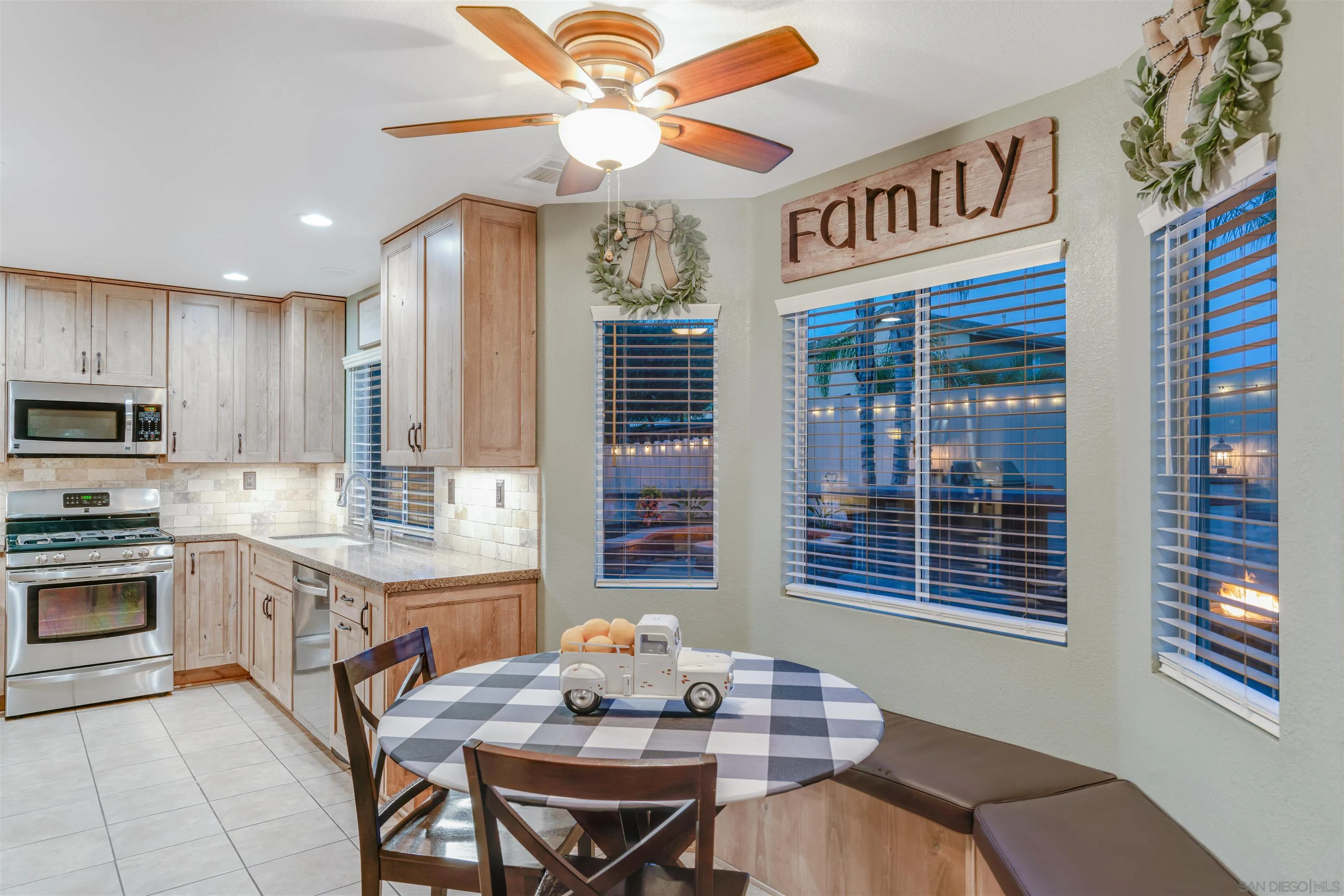 10229 Pinon Place Lakeside, CA 92040 - Photo 11 of 33 a kitchen with stainless steel appliances granite countertop a stove a sink dishwasher and cabinets with wooden floor