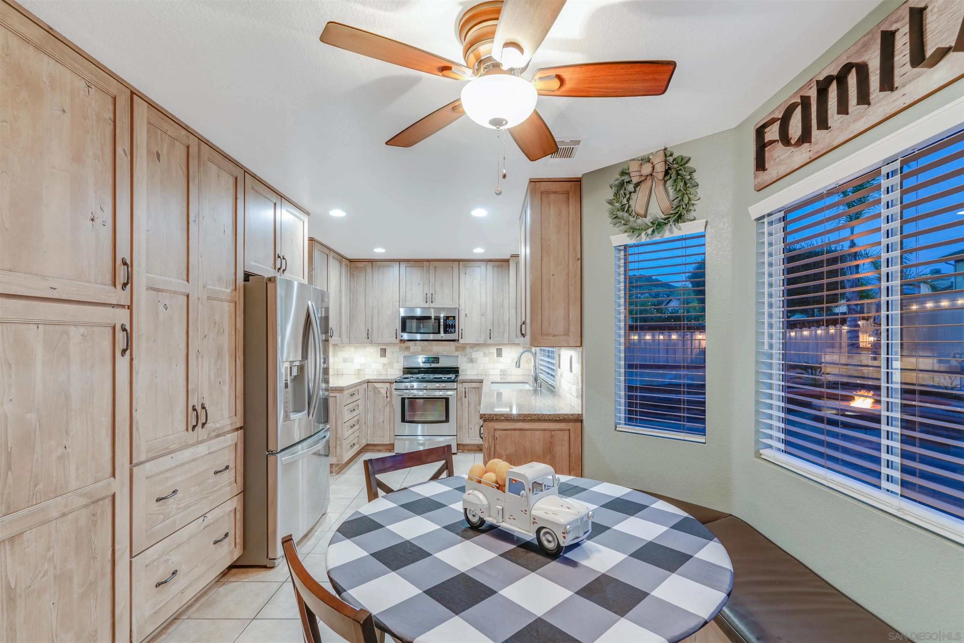 10229 Pinon Place Lakeside, CA 92040 - Photo 12 of 33 a kitchen with stainless steel appliances kitchen island granite countertop a refrigerator cabinets and wooden floor