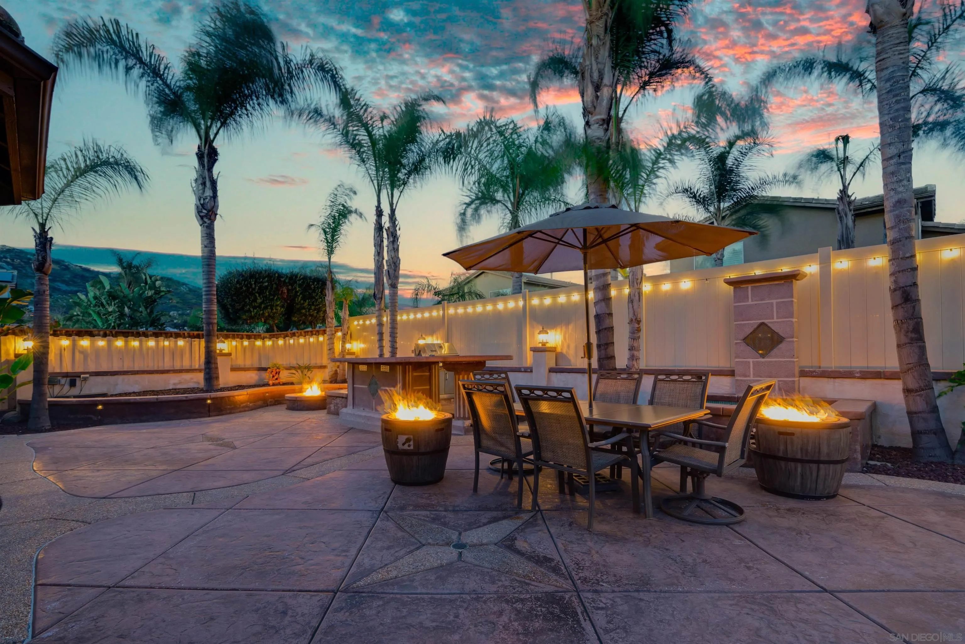 10229 Pinon Place Lakeside, CA 92040 - Photo 20 of 33 a view of a patio with dining table and chairs under an umbrella