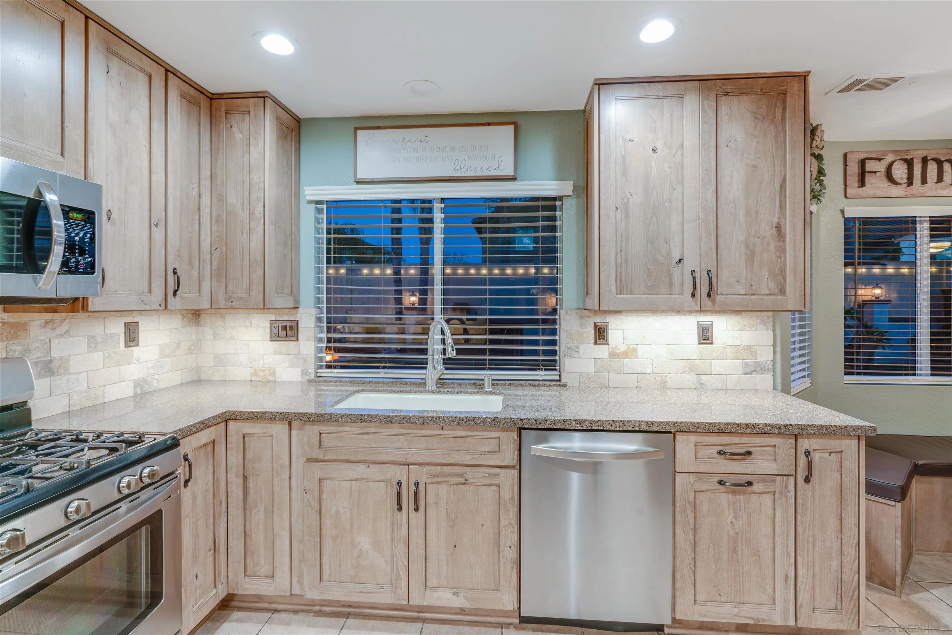 10229 Pinon Place Lakeside, CA 92040 - Photo 10 of 33 a kitchen with granite countertop a sink cabinets stainless steel appliances and a window