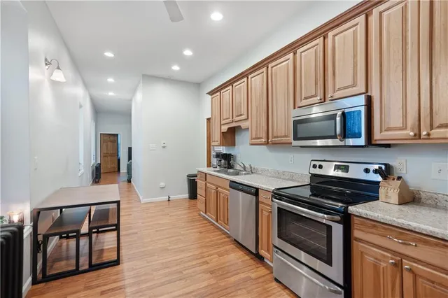 a kitchen with stainless steel appliances granite countertop a stove a sink and a microwave