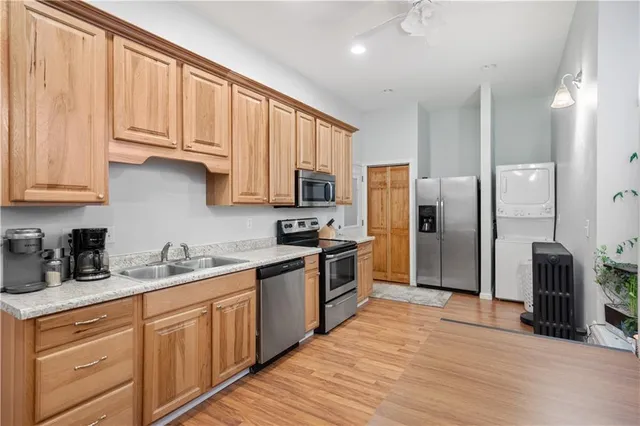 a kitchen with stainless steel appliances granite countertop a refrigerator and cabinets