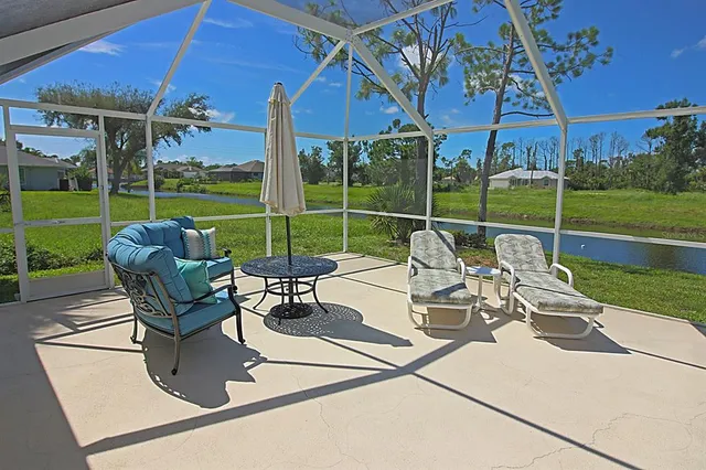 a aerial view of a house with a yard basket ball court and outdoor seating