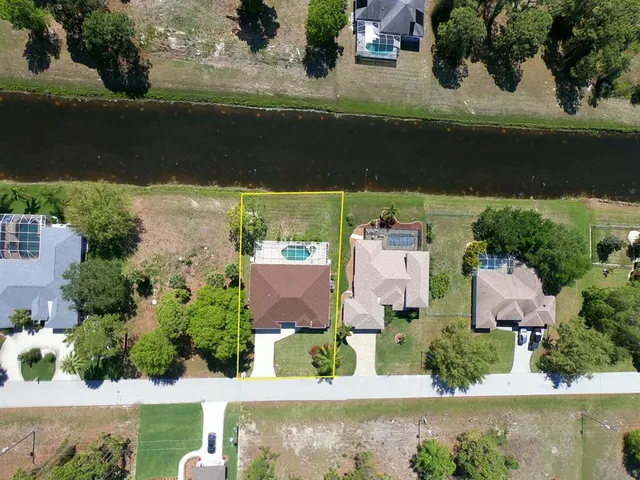 a view of a backyard with swimming pool