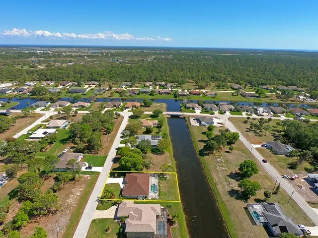 a view of a patio with table and chairs a refrigerator and wooden floor