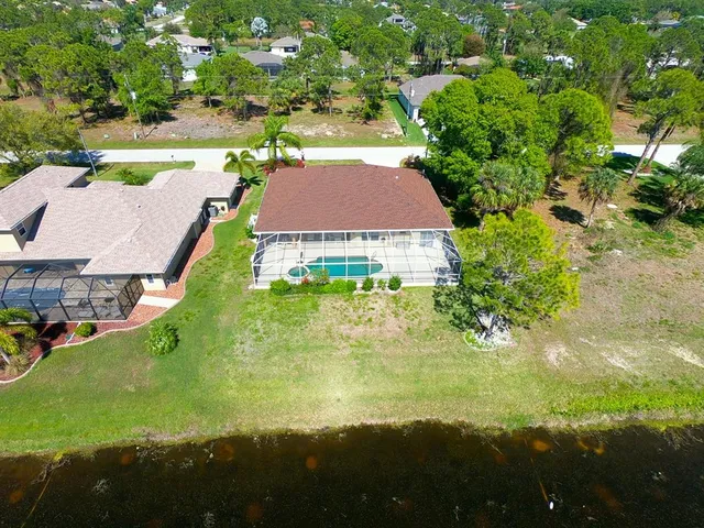 a front view of house with yard and swimming pool