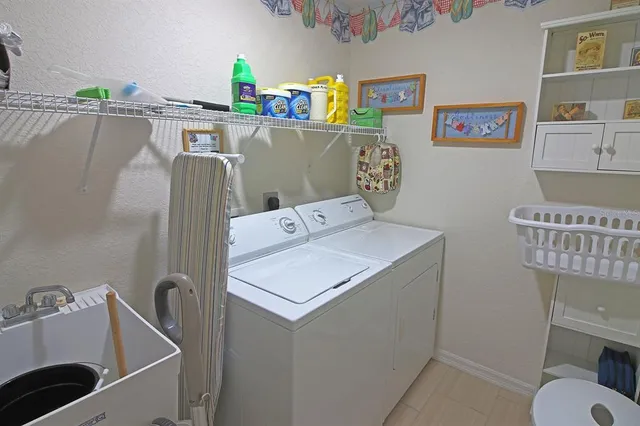 a bathroom with a double vanity sink a toilet and shower