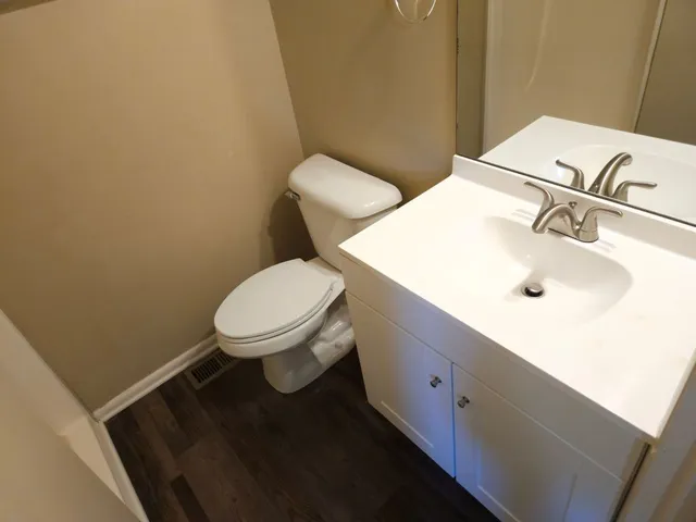 a white toilet sitting next to a bathroom sink